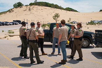 A park ranger talks with staffers at Warren Dunes.