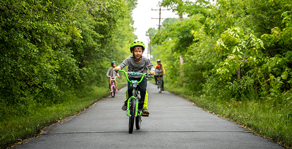 Kids cycling on a paved pathway