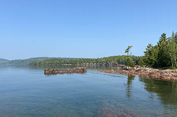 view of cove surrounded by rocky terrain and trees