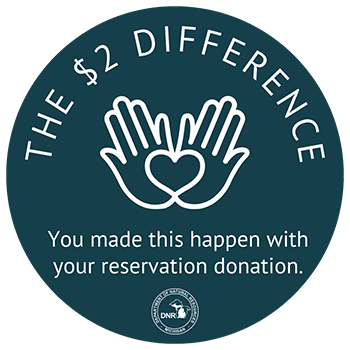 sticker that reads "The $2 Difference. You made this happen with your reservation donation."