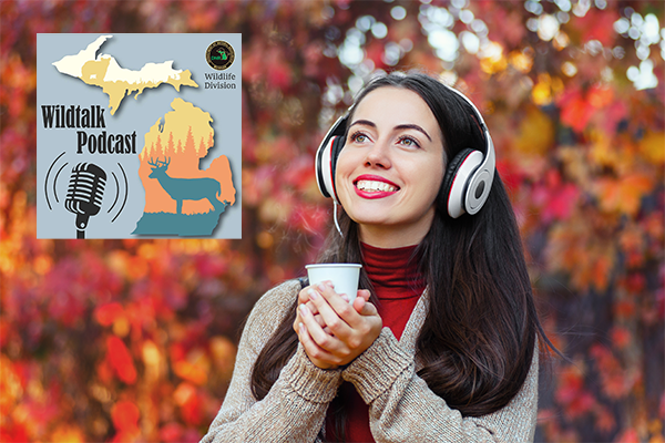 A woman with headphones has a hot beverage outside during the fall. 