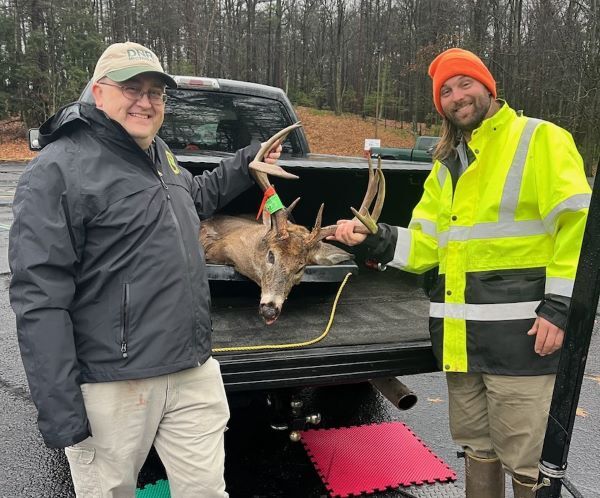 Wildlife Division employees, Colter Lubben and Joe Sage, check in a ten-point white-tailed buck.