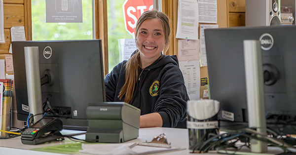 summer park worker sitting at desk in contact booth