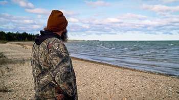 Aaron Jones is shown along the Lake Michigan beach at Wilderness State Park.