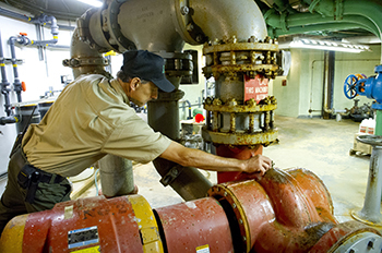 staff person working in lower bowl of fountain