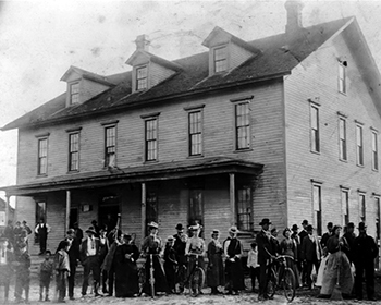People standing outside the Shelton House during the working era of the Fayette townsite.