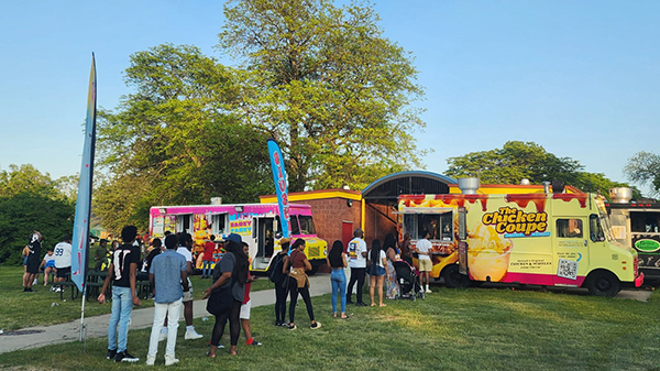 People line up for food at the Chicken Coupe on Belle Isle in Detroit.