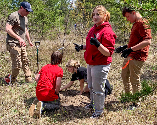 Students plant trees in Alger County's Burt Township.