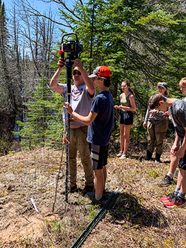 Students plant trees in Alger County's Burt Township.