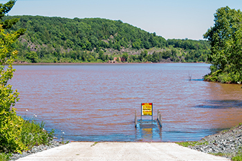 An upstream beaver pond drained, causing reddish sediment in the water and water level rise on Lake Angeline.