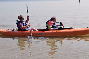 A couple of kayakers enjoy the water at DiversAbility Day at Interlochen State Park.