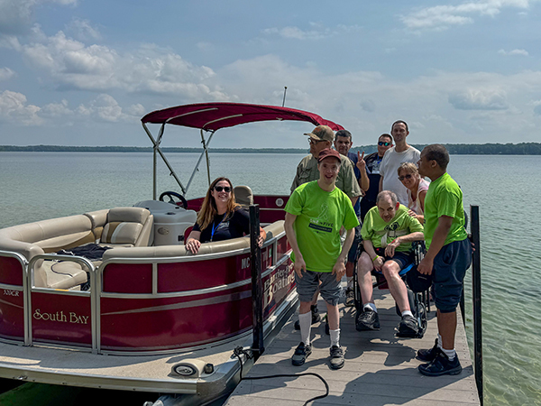 A group of participants had fun on a pontoon ride during DiversAbility Day at Interlochen State Park.