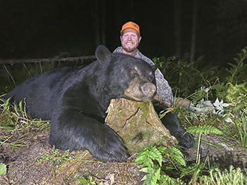 Don Brown pictured with a black bear he harvested.