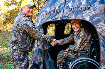 Two hunters shake hands in the field, part of the growing number of people involved in Hunters Feeding Michigan.
