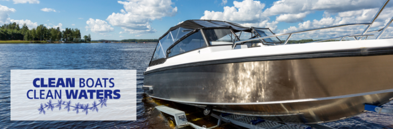 A boat being launched from a trailer into a lake. The Clean Boats, Clean Waters logo appears on the left side of the photo.