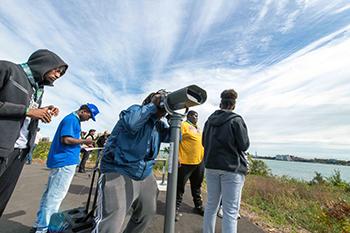 Visitors check out an EnChroma viewer at Milliken State Park in Detroit.
