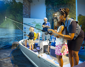 mother and daugther simulating fishing in a boat