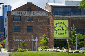 An external photograph is shown of the Outdoor Adventure Center in Detroit.