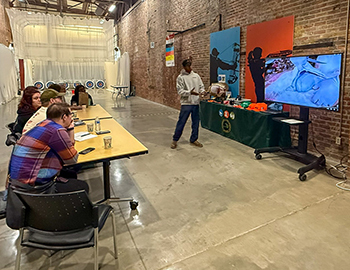 Participants are shown receiving classroom instruction at the Outdoor Adventure Center in Detroit.