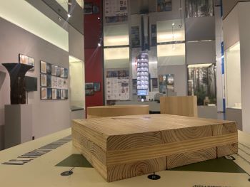 A close up of Mass Timber material samples and a charred column after fire testing.