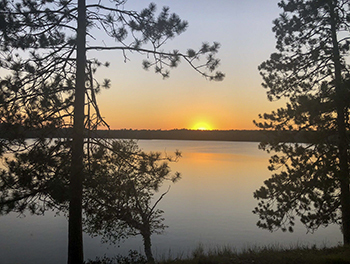 A sunset is shown on the Black River Ranch property.