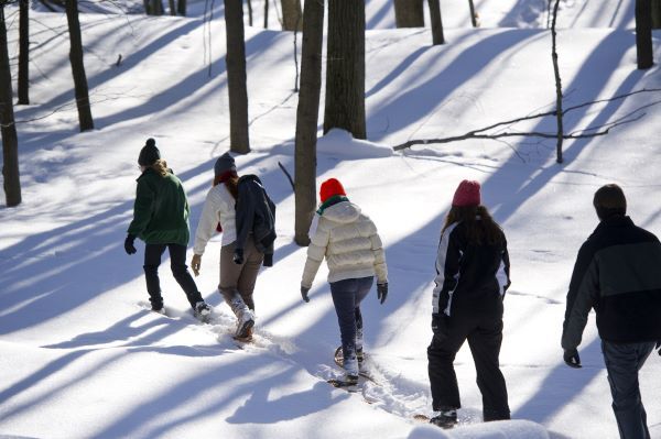 Hikers walk through snow