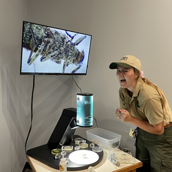 A DNR educator excitedly uses a new hands-on station