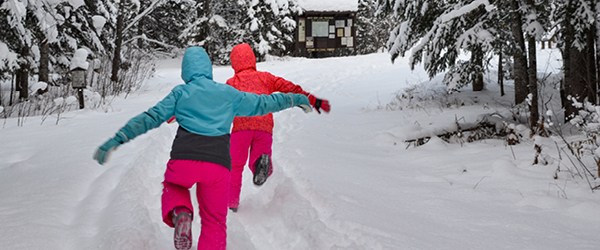 Two kids playing in the snow
