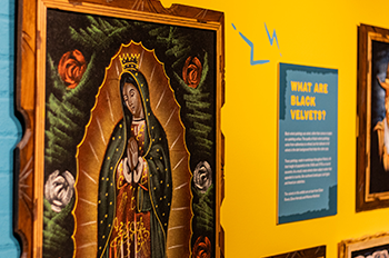 Close up of a black velvet painting.