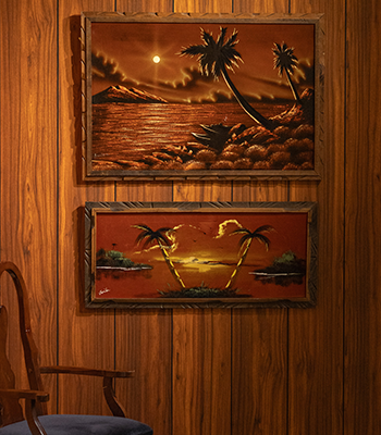 A close up of two black velvet paintings.