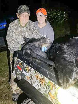Milton Miller and Anne Christman are shown with Miller's bear harvest.