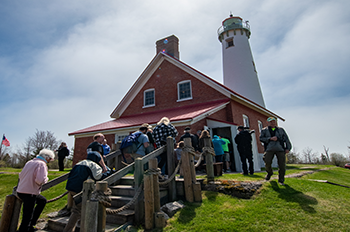 A group of people entering the lighthouse.