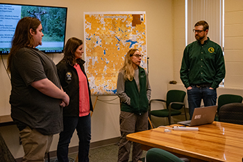 Study leads from the KBIC, NMU and Michigan DNR discuss the moose collaring project with media in 2025.