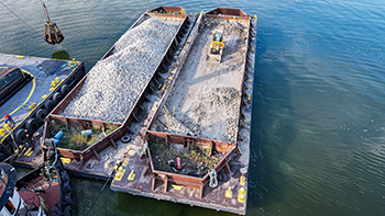 Pieces of limestone, quarried locally in the Thumb area, were moved out to the reef location on barges. 