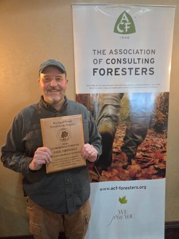 Paul Drysdale accepts the 2026 Stewardship Forester award at the Michigan Association of Consulting Foresters meeting in February.