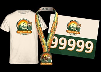 Happy Little Trees 5k 2026 race swag, with orange, green and yellow colors highlighting a T-shirt, finisher's medal and race bib