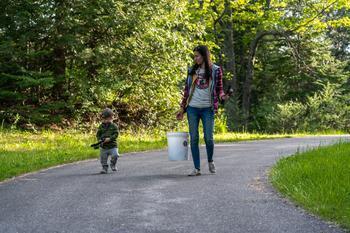 A parent and child holding fishing rods.