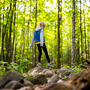 Young girl walking in the woods