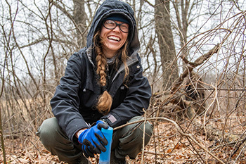 a smiling volunteer holding an instrument