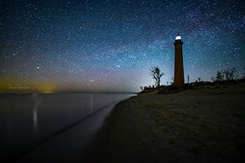 view of night sky above a lighthouse