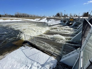 Water flows out of the Cheboygan Dam gates this afternoon.