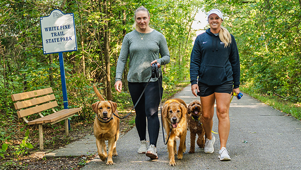 two people walking dogs on White Pine Trail