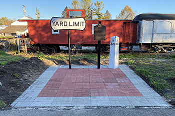 historical marker and old rail car along trail