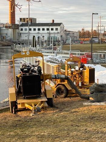 An aerial view of the Cheboygan Lock and Dam shows water coming through the dam into the spillway. Precautions are being taken to keep from flooding.