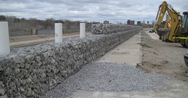 View of construction work to place gabion baskets and fencing along the Flint River, just east of Chevrolet Avenue.