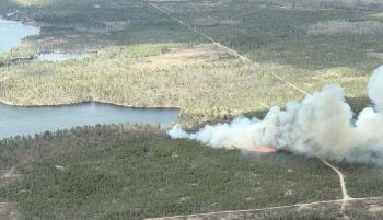 A plume of smoke May 10 from the Tomahawk Lake fire, which is now 100 percent contained. 
