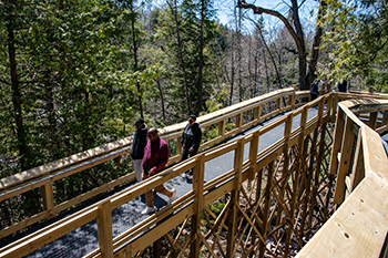 Park visitors enjoy the new boardwalk Thursday at the Upper Tahquamenon Falls.
