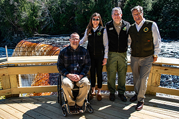 DNR officials pose for a photo with Bryan Wilkinson, co-chairman of the Accessibility Advisory Council, left, at the Upper Falls deck. 