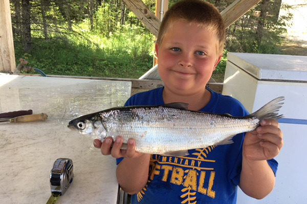 Youth angler holding a fish.