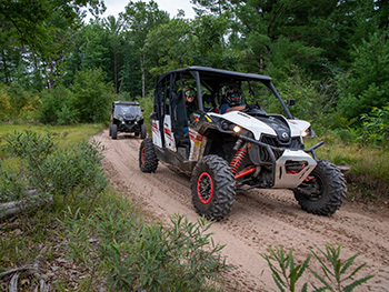 Two ORVs riding on trail